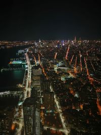 Aerial view of illuminated city at night