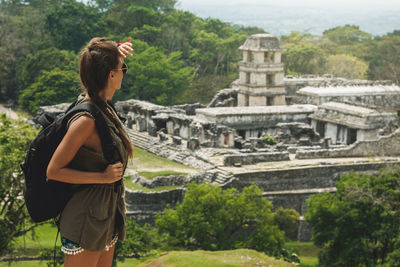 Rear view of woman standing against built structures