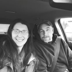 Portrait of smiling woman sitting in car