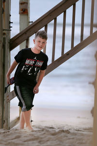 Full length portrait of boy standing on beach
