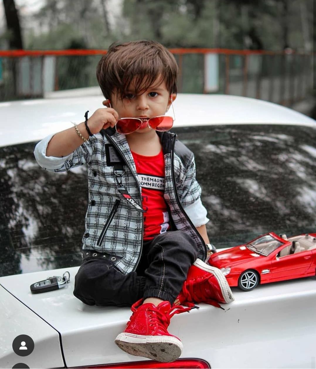child, childhood, car, motor vehicle, one person, boys, males, real people, mode of transportation, men, full length, winter, innocence, lifestyles, cute, day, casual clothing, toy car, outdoors, warm clothing