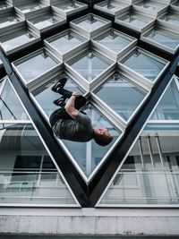 Low angle view of man on window of building