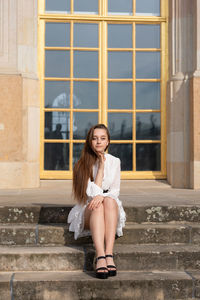Portrait of a smiling young woman sitting outdoors