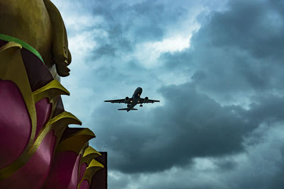 Low angle view of airplane flying in sky