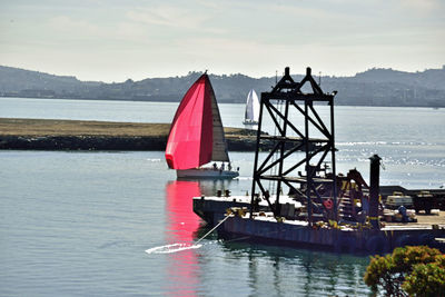 Red boat in sea against sky