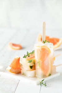 Grapefruit thyme popsicles against a light background.