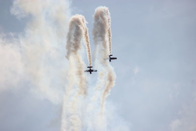 Low angle view of airshow against sky