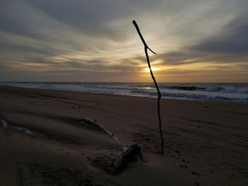 Scenic view of beach against sky during sunset