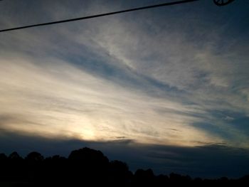 Low angle view of silhouette trees against sky at sunset