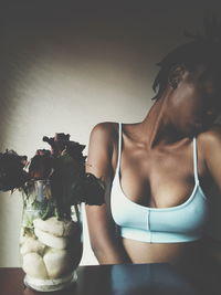 Close-up of young woman sitting in vase