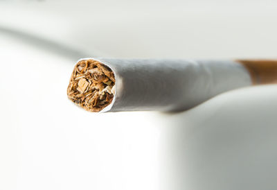 Close-up of cigarette against white background