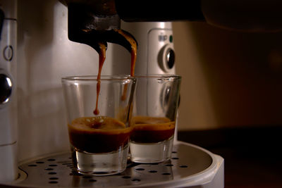 Close-up of coffee pouring in glass