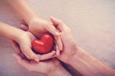 Midsection of woman holding heart shape