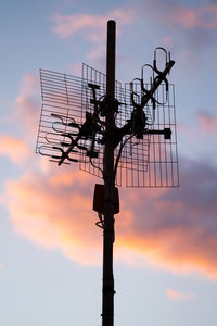 Sunset sky with antenna on the foreground