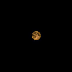 Low angle view of moon against clear sky at night