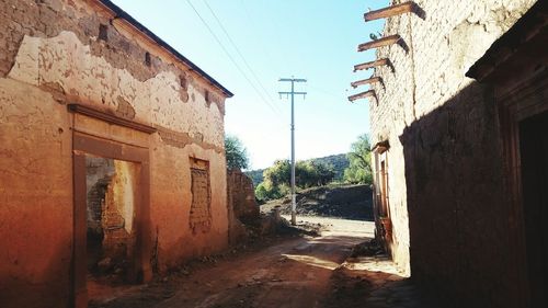 Street amidst buildings against clear sky