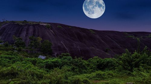 Scenic view of mountains against full moon night sky