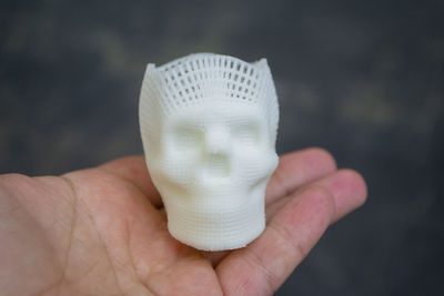 Close-up of hand holding seashell