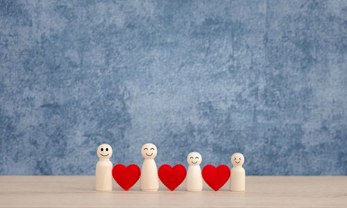 Close-up of toys on table against blue background