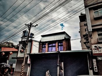 Low angle view of electricity pylon against sky