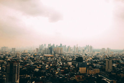 High angle view of modern buildings in city against sky