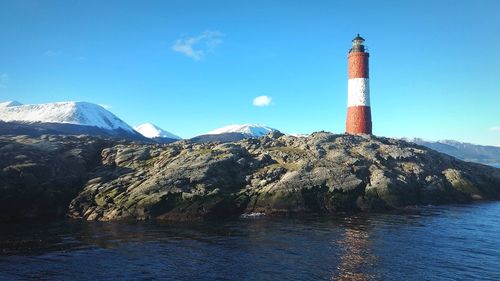 Les eclaireur lighthouse bathed by the beagle channel, with the snow covered andes in the background