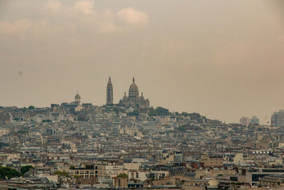 Aerial view of townscape against sky in city