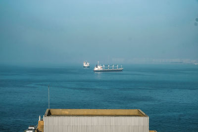 Ship sailing on sea against sky