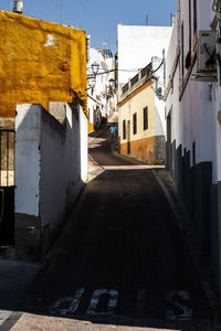 Empty alley amidst buildings in city