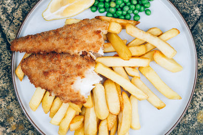 High angle view of bread and fries in plate on table