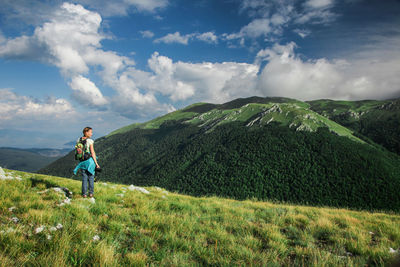 Woman on mountain against sky