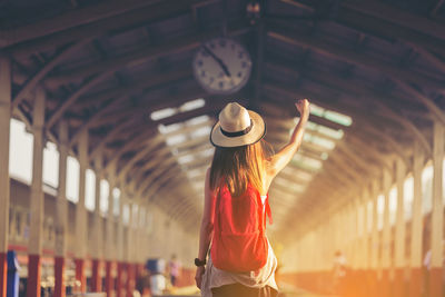 Rear view of woman at railroad station