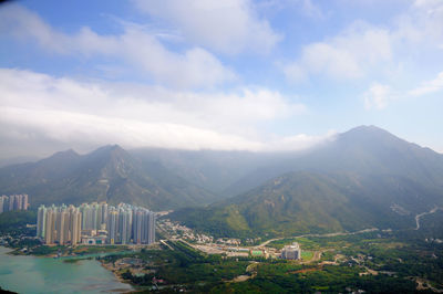 Cityscape against cloudy sky