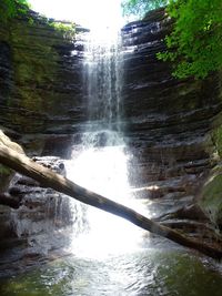 Scenic view of waterfall against sky