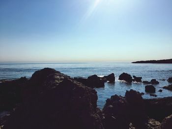 Scenic view of sea against clear sky during sunset