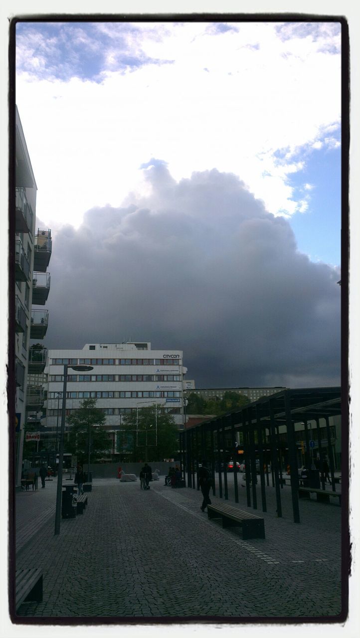 sky, transfer print, architecture, built structure, cloud - sky, building exterior, auto post production filter, cloudy, city, cloud, large group of people, day, incidental people, city life, railing, outdoors, in a row, chair, fence