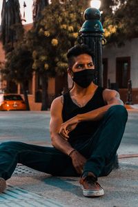 Portrait of young man sitting outdoors