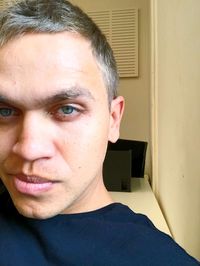 Close-up portrait of young man at home