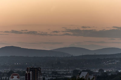 Aerial view of townscape against sky during sunset