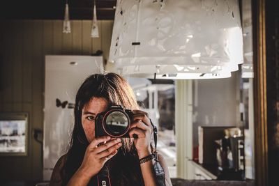 Portrait of woman photographing