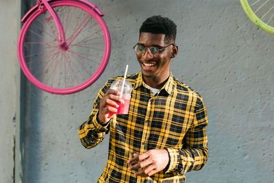 Side view of young man using mobile phone