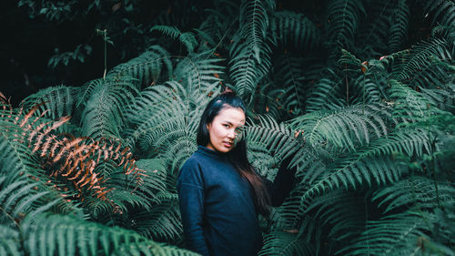 Portrait of smiling young woman with tree