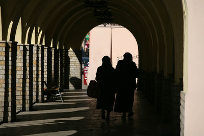 Silhouette people in corridor of building