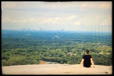 Rear view of woman sitting on bench