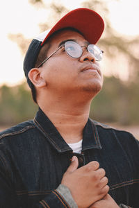 Young man wearing cap while looking away 