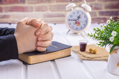 High angle view of baby hand on table at home