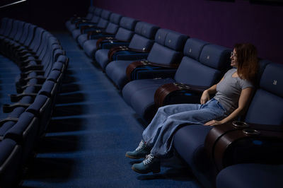 Low section of man sitting in train