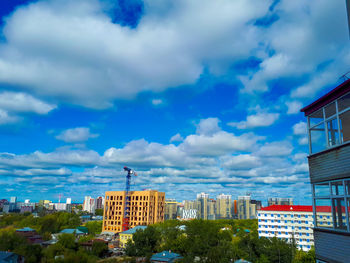 Low angle view of buildings against cloudy sky