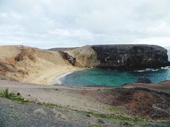 Scenic view of mountains against cloudy sky