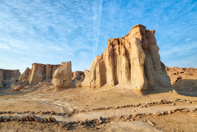 Rock formations on landscape against sky